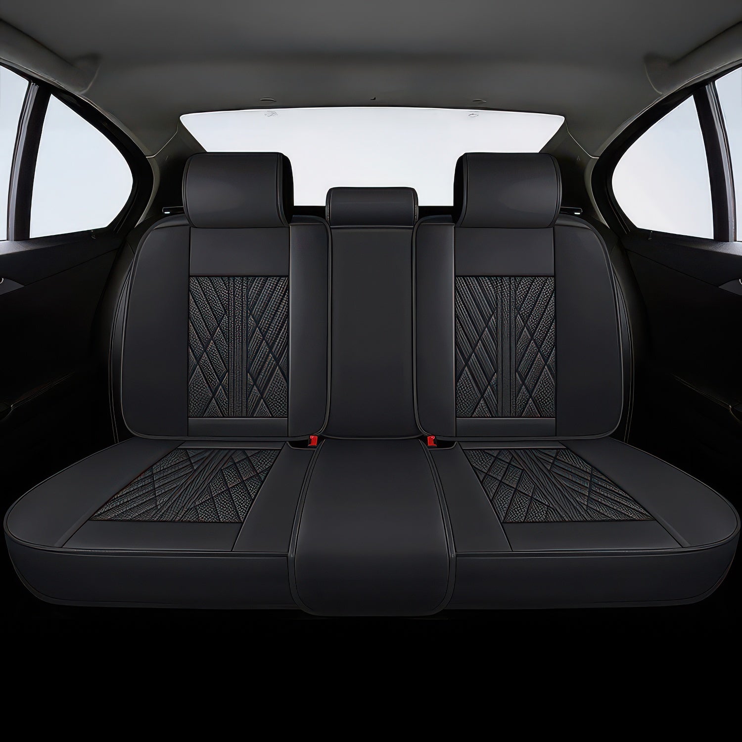 Black rear car seat covers with a geometric pattern on the backrests in a car interior.